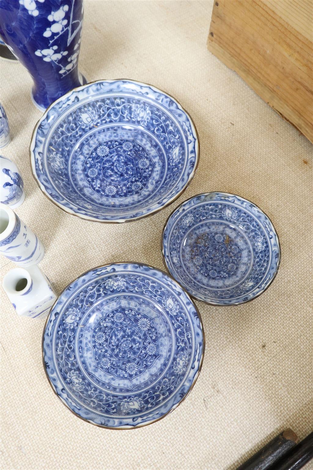 A graduated set of three Chinese porcelain blue and white bowls, largest 19cm and a group of four miniature Chinese blue and white vase